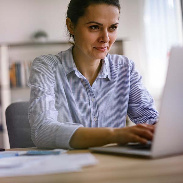 Happy woman working on laptop